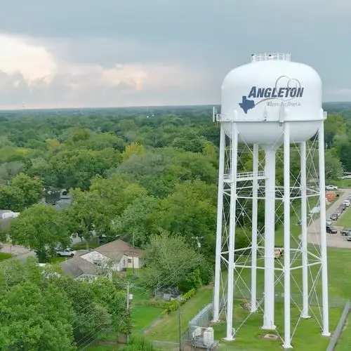 Angleton water tower above a residential neighborhood.