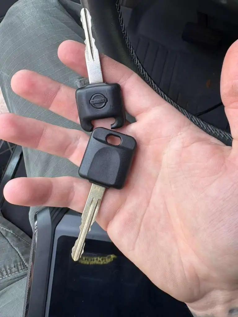 Two vehicle keys held during a car key replacement job